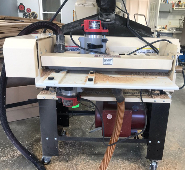 Darrell chose the 25" Woodmaster. Here, he has it set up with the 3-Side Molding attachment allowing him to shape 3 sides of his flooring in a single pass. The planer cuts the back relief and the 2 Milwaukee routers shape the tongue and groove sides. 3 sides, 1 pass.