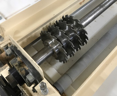 Darrell snapped a picture of the business end of his Woodmaster set up as a gang rip saw. The variable feed rate is adjustable from 0 to 16 feet per minute. In goes a single board, out comes four perfect blanks for casing or trim.